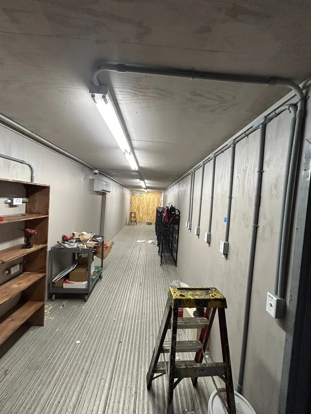Overhead conduit and fluorescent lighting installed by Whitehouse Electric LLC in a Southeast Georgia commercial hallway.